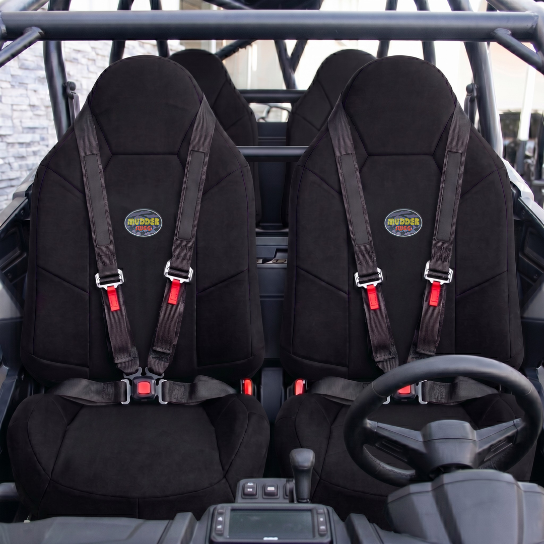 Polaris RZR Crew front-row bucket seats covered in MudderSwag black padded neoprene with 4-point harness installed